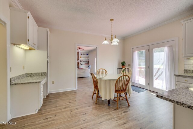 3502 Bondwood Cir, Johnson City, TN 37604 - dining space with light wood-type flooring, a textured ceiling, ornamental molding, and a chandelier