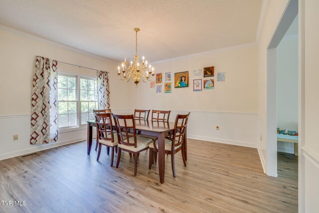 3502 Bondwood Cir, Johnson City, TN 37604 - dining space featuring crown molding, a chandelier, light wood finished floors, baseboards, and a textured ceiling