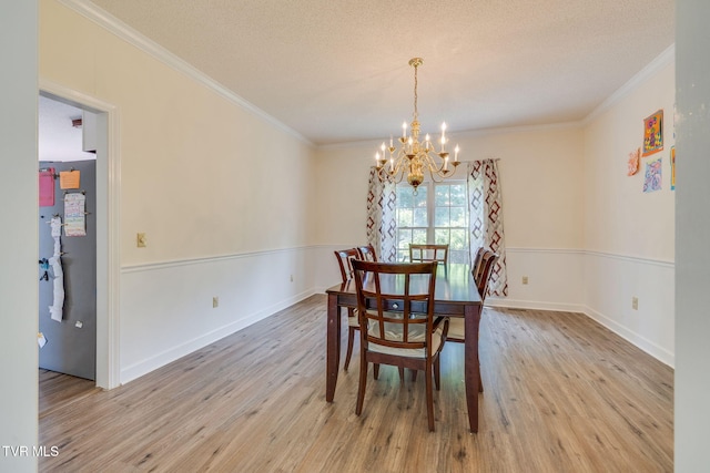 3502 Bondwood Cir, Johnson City, TN 37604 - dining room with a chandelier, crown molding, light wood-style floors, a textured ceiling, and baseboards