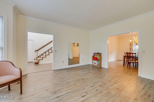 3502 Bondwood Cir, Johnson City, TN 37604 - sitting room with ornamental molding, a chandelier, light wood-style floors, stairs, and baseboards