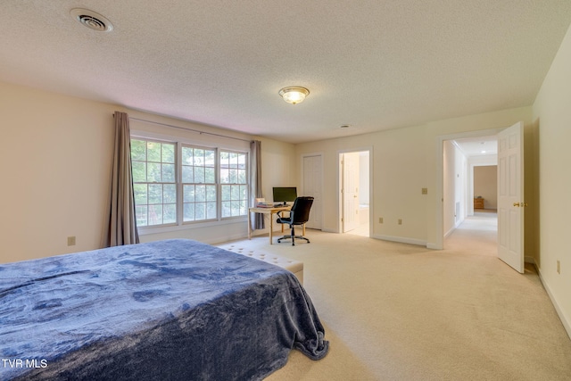 3502 Bondwood Cir, Johnson City, TN 37604 - bedroom with light colored carpet, baseboards, a textured ceiling, connected bathroom, and a desk