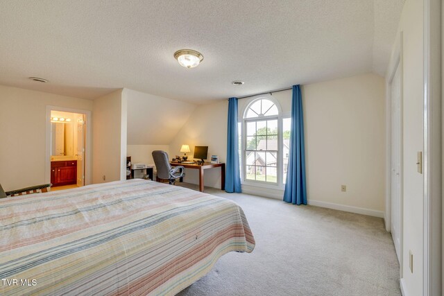 3502 Bondwood Cir, Johnson City, TN 37604 - bedroom with a textured ceiling, light carpet, vaulted ceiling, ensuite bath, and baseboards