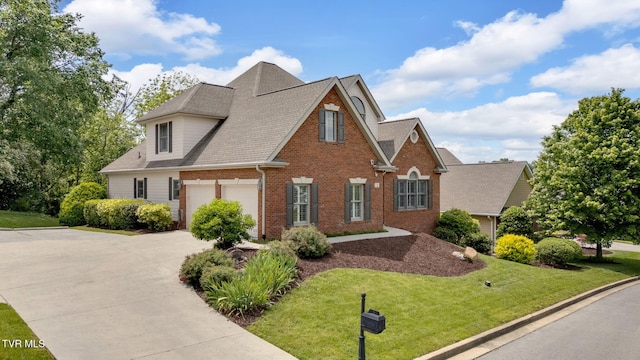 5 Fox Run Ln, Johnson City, TN 37604 - traditional-style house with brick siding, concrete driveway, a garage, a front lawn, and roof with shingles