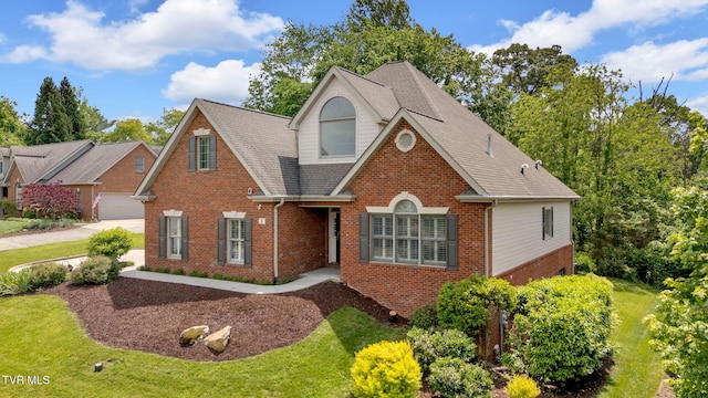 5 Fox Run Ln, Johnson City, TN 37604 - view of front of house with brick siding, a garage, roof with shingles, and a front yard