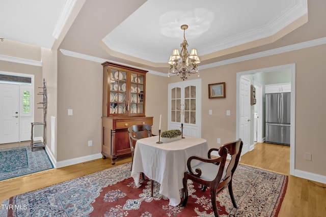 5 Fox Run Ln, Johnson City, TN 37604 - dining space with a chandelier, a tray ceiling, light wood-type flooring, ornamental molding, and baseboards