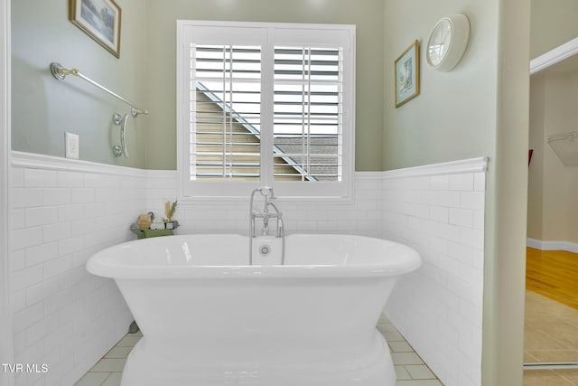 5 Fox Run Ln, Johnson City, TN 37604 - full bathroom with tile walls, a soaking tub, a wainscoted wall, and tile patterned floors