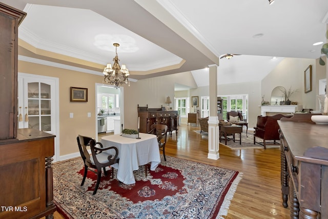 5 Fox Run Ln, Johnson City, TN 37604 - dining room featuring light wood-type flooring, ornamental molding, a chandelier, baseboards, and decorative columns