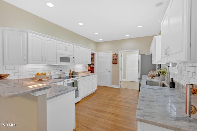 5 Fox Run Ln, Johnson City, TN 37604 - kitchen featuring white appliances, white cabinetry, a peninsula, backsplash, and recessed lighting