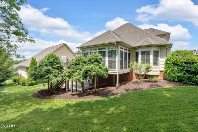 5 Fox Run Ln, Johnson City, TN 37604 - back of property featuring a lawn, roof with shingles, and a sunroom