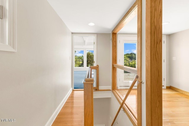 entryway with light wood finished floors, baseboards, and recessed lighting