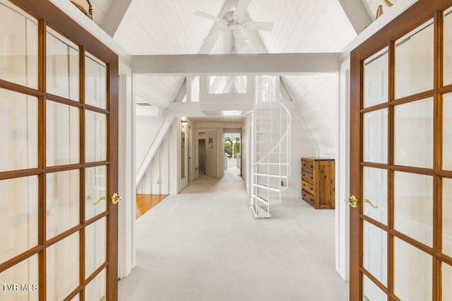 hall with french doors, light colored carpet, and wood ceiling