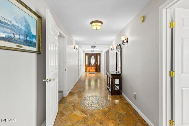 hall featuring baseboards