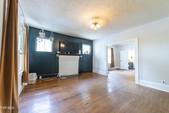 1496 Old State Route 34, Telford, TN 37690 - unfurnished living room with a textured ceiling, hardwood / wood-style flooring, and baseboards
