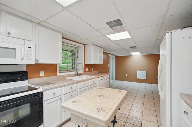 8020 Rock Switch Rd, Wise, VA 24293 - kitchen with white appliances, a sink, a paneled ceiling, and white cabinetry