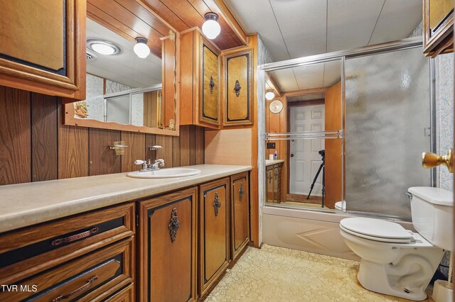 8020 Rock Switch Rd, Wise, VA 24293 - bathroom featuring toilet, wooden walls, vanity, and shower / bath combination with glass door