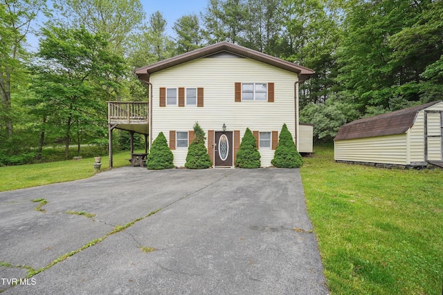 8020 Rock Switch Rd, Wise, VA 24293 - view of front of home with a storage unit, an outdoor structure, asphalt driveway, a front yard, and a wooden deck