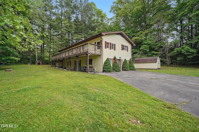 8020 Rock Switch Rd, Wise, VA 24293 - view of front of home with driveway, a front lawn, an outdoor structure, a wooden deck, and a storage unit