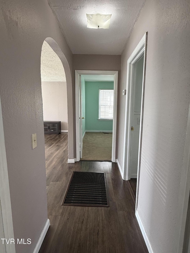 379 SW Oakland St, Abingdon, VA 24210 - corridor with arched walkways, wood finished floors, baseboards, a textured ceiling, and a textured wall