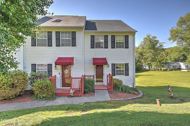 townhome / multi-family property with a front lawn