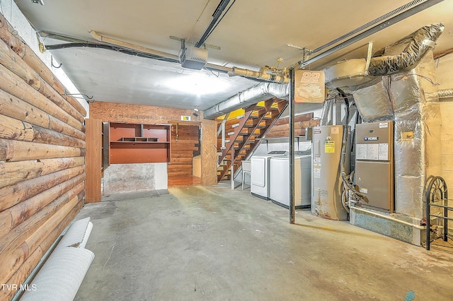 below grade area featuring water heater, washer and clothes dryer, heating unit, and stairway