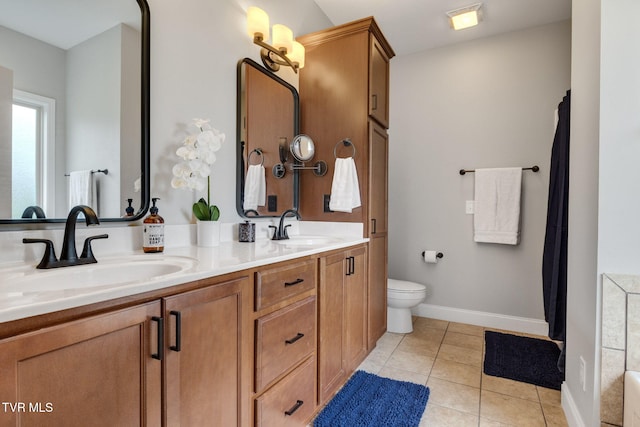 134 Chancery Ct, Piney Flats, TN 37686 - full bathroom with double vanity, tile patterned flooring, toilet, and baseboards