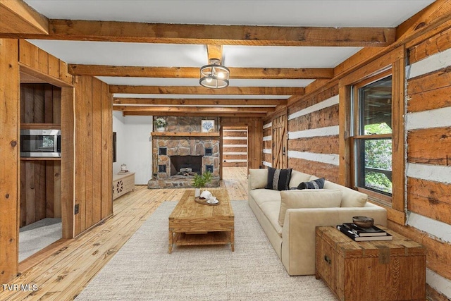 2318 Westwood St, Johnson City, TN 37604 - living area featuring light wood-style floors, beamed ceiling, wooden walls, and a stone fireplace