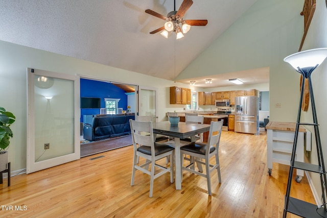 212 Old Castle Rd, Kingsport, TN 37660 - dining space featuring ceiling fan, light wood finished floors, and high vaulted ceiling