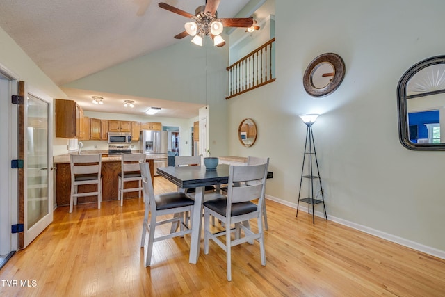 212 Old Castle Rd, Kingsport, TN 37660 - dining room with a ceiling fan, light wood-style floors, baseboards, and high vaulted ceiling