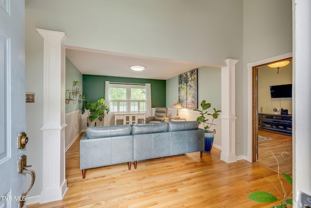 212 Old Castle Rd, Kingsport, TN 37660 - living room featuring ornate columns, light wood-type flooring, and a towering ceiling