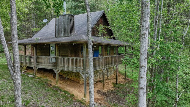 240 Old Railroad Grade Rd, Roan Mountain, TN 37687 - rear view of property featuring a shingled roof and a view of trees