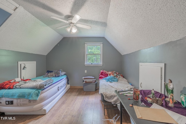 240 Old Railroad Grade Rd, Roan Mountain, TN 37687 - bedroom with wood finished floors, lofted ceiling, a textured ceiling, a ceiling fan, and baseboards
