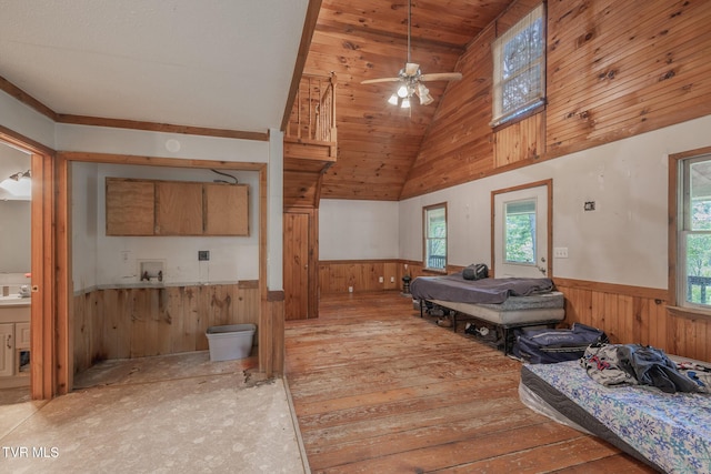 240 Old Railroad Grade Rd, Roan Mountain, TN 37687 - sitting room with wainscoting, wooden walls, light wood-style flooring, high vaulted ceiling, and ceiling fan