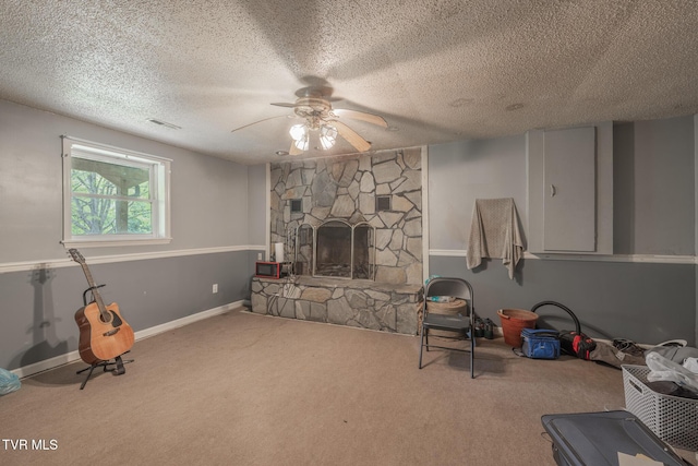 240 Old Railroad Grade Rd, Roan Mountain, TN 37687 - unfurnished living room featuring carpet floors, ceiling fan, a fireplace, a textured ceiling, and baseboards