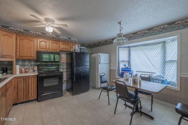 240 Old Railroad Grade Rd, Roan Mountain, TN 37687 - kitchen with black appliances, brown cabinetry, a ceiling fan, light countertops, and decorative light fixtures