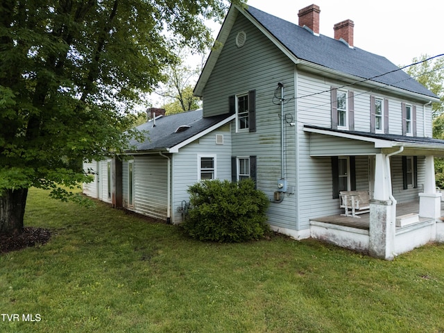 380 Oak Grove Rd, Johnson City, TN 37615 - view of home's exterior with a porch, a chimney, a yard, and roof with shingles