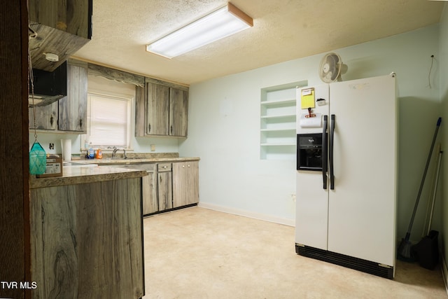 380 Oak Grove Rd, Johnson City, TN 37615 - kitchen with white refrigerator with ice dispenser, a textured ceiling, a sink, and baseboards