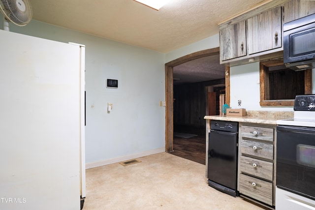 380 Oak Grove Rd, Johnson City, TN 37615 - kitchen featuring electric range oven, freestanding refrigerator, arched walkways, light countertops, and a textured ceiling