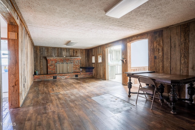 380 Oak Grove Rd, Johnson City, TN 37615 - bar area featuring wood walls, wood-type flooring, a fireplace, a textured ceiling, and plenty of natural light