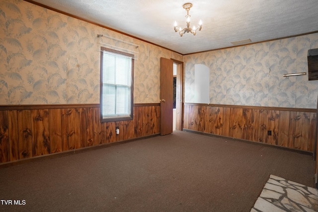 380 Oak Grove Rd, Johnson City, TN 37615 - unfurnished room featuring wainscoting, a chandelier, crown molding, wooden walls, and a textured ceiling