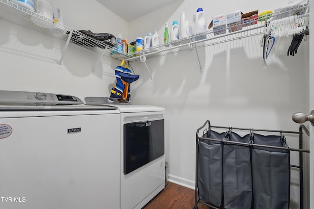 laundry area featuring washing machine and clothes dryer and dark wood-style floors
