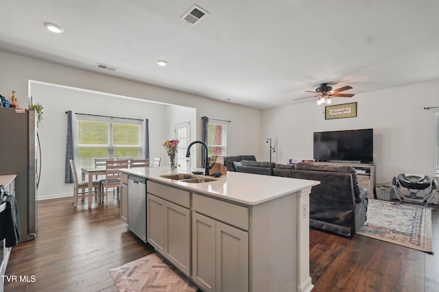 kitchen with a sink, appliances with stainless steel finishes, gray cabinets, light countertops, and ceiling fan