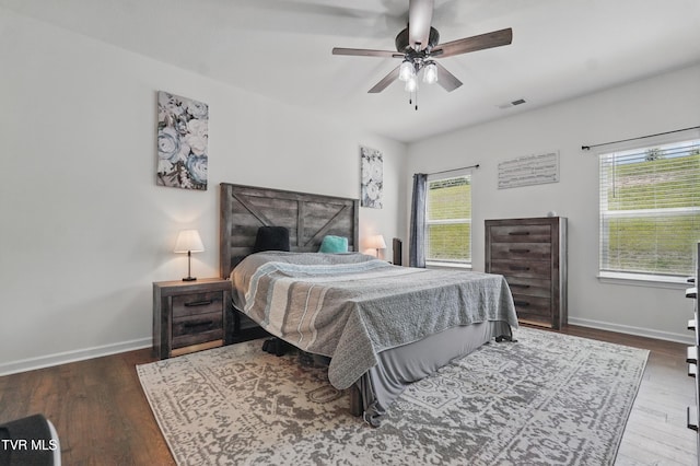 bedroom featuring wood finished floors, baseboards, and ceiling fan