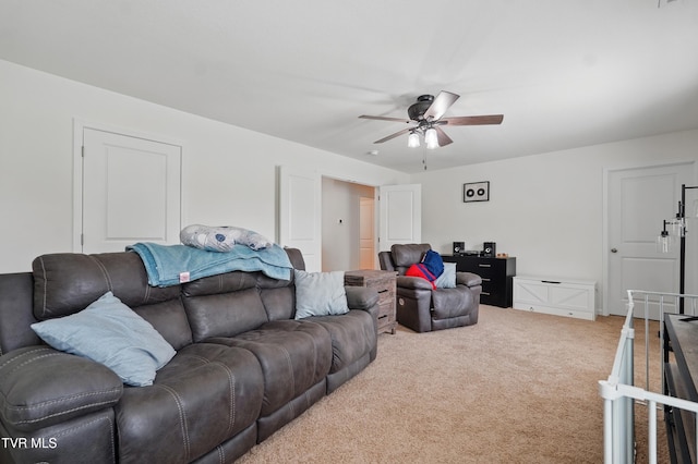 carpeted living room featuring ceiling fan