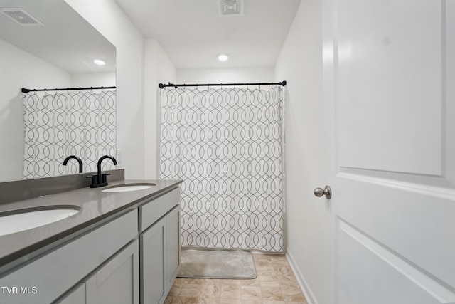 bathroom with double vanity, a shower with curtain, and recessed lighting