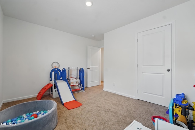 game room featuring carpet floors and baseboards