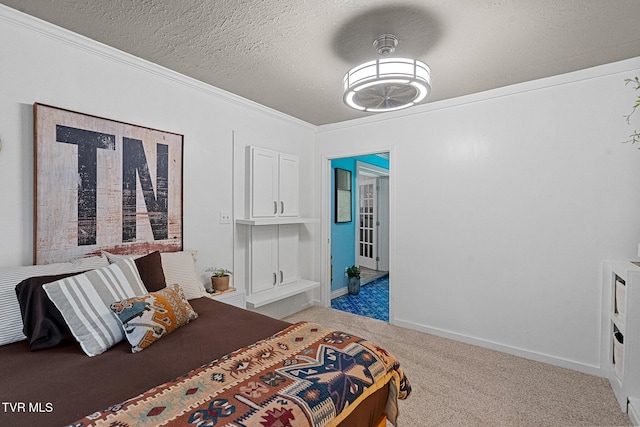 bedroom featuring carpet floors, ornamental molding, a textured ceiling, and baseboards