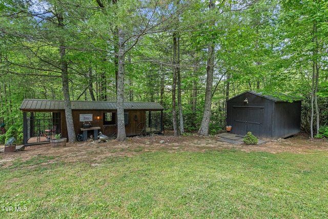 view of green lawn with an outbuilding and a shed