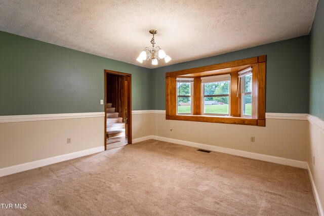 2482-2480 Elk Way, Newport, TN 37821 - unfurnished room with a chandelier, carpet flooring, a textured ceiling, baseboards, and stairs
