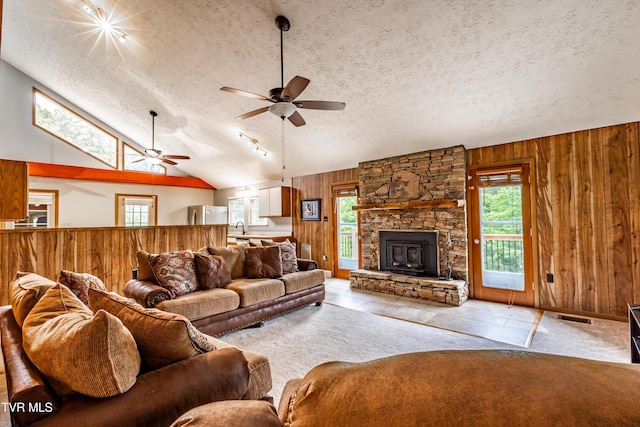 2482-2480 Elk Way, Newport, TN 37821 - living area with wooden walls, a ceiling fan, vaulted ceiling, a textured ceiling, and a fireplace