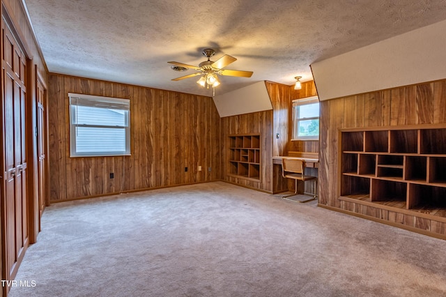 2482-2480 Elk Way, Newport, TN 37821 - unfurnished living room featuring wood walls, ceiling fan, a textured ceiling, carpet, and built in shelves